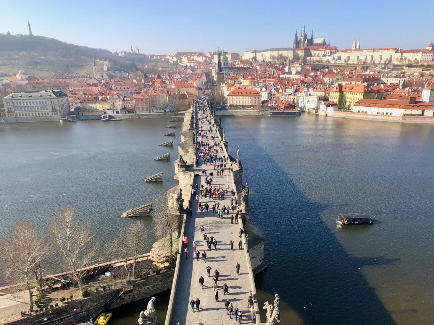 Prague's Charles Bridge from the Old Town Tower, showing off the Gothic bridge, Baroque statues, and varied architecture of Lesser Town.