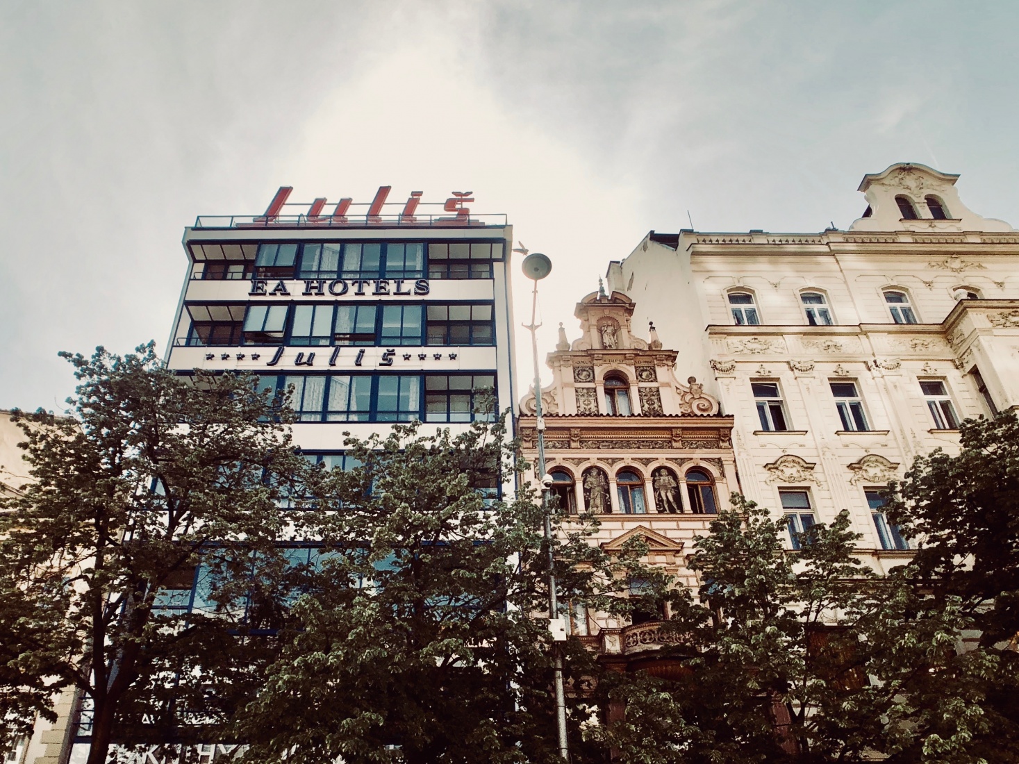 Hotel Juliš, a building from the Functionalist movement of architecture from 1932, in central Wenceslas Square, Prague. Immediately to the right is a 19th century Neo Renaissance palais.